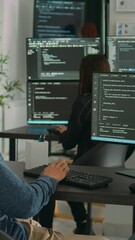 Vertical video: Asian software engineer working on security program with server code, typing system information on computer screen. Database programer writing code with algorithms, it language.