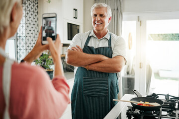 Canvas Print - Senior man, phone and cooking photograph by woman for social media, live streaming or food vlog in Canada house kitchen. Smile, happy or confident home chef for about us website picture on technology