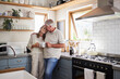 © Nina Lawrenson/peopleimages.com - Love, kitchen and senior couple relax with cup of coffee, tea or hot drink while bonding and connect at home. Family, peace and elderly man and woman enjoy quality time, retirement and life together