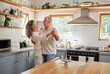 © N Lawrenson/peopleimages.com - Dance, couple and kitchen with a senior man and woman dancing together in a retirement home. Love, freedom and romance with an elderly male and female pensioner having fun in a house in the morning