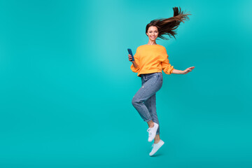 Canvas Print - Full body size photo of young attractive pretty nice woman jump air walk go hold phone blogger popular internet isolated on cyan color background