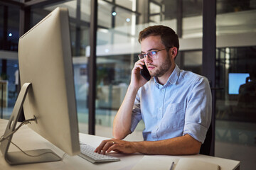 Poster - Business, communication and overtime, phone call and man with computer at desk. Late night at office, working on deal or project. Corporate worker in glasses, typing online and talking on smartphone.