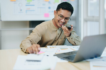 business owner or Asian male marketers are using business phones, calculator and computers to do office work