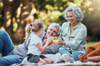 © Clement C/peopleimages.com - Juice, vitamin c and family picnic with child and grandparents for healthy growth development, outdoor wellness lifestyle. Senior grandmother, elderly people and girl with orange drink in bokeh park