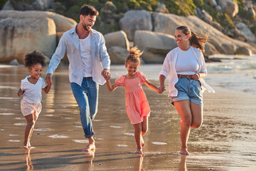 Wall Mural - Beach, parents and kids happy, relax and enjoy holiday, vacation and break on sand barefoot. Mom, dad and children smile, running and walk while being playful on summer seaside family trip together.