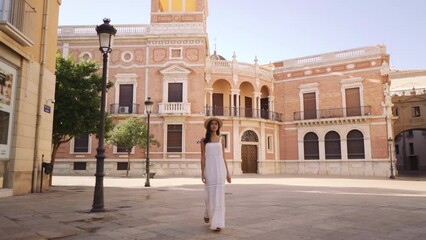 Wall Mural - Attractive elegant female walking on the streets in Valencia