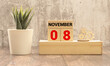 Wooden calendar November 08 on a white background close up.