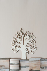 Canvas Print - stylized tree with curly branches set in landscape design with pieces of cut birch bark