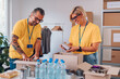 © Zamrznuti tonovi - Group of volunteers working in community charity donation center
