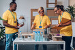 © Zamrznuti tonovi - Group of multiracial volunteers working in community charity donation center