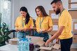 © Zamrznuti tonovi - Group of volunteers working in community charity donation center