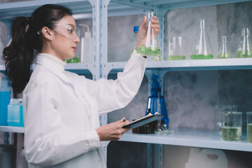 Wall Mural - Researcher chamical are seeing the samples in glasses in the laboratory. Young scientists are happy in making beauty care products.