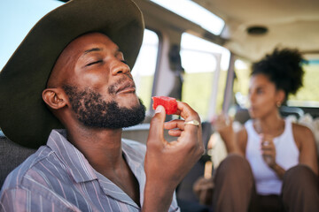 Wall Mural - Black man, eating watermelon and summer fruit on safari game drive in sustainability nature or environment landscape travel. Smile, happy tourist or couple and diet health food in Kenya national park