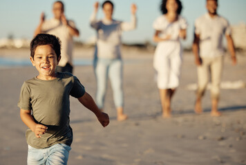 Canvas Print - Boy, running and beach with family, happy and cheerful while walking in the sand. Young male child by ocean, run on shore in summer, parents and grandparents have joyful time together in background