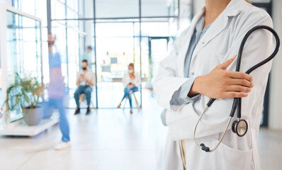 Medical healthcare doctor, woman worker or employee arms crossed confident with stethoscope in busy hospital. Leadership, work or wellness female staff manager nurse working in medicine clinic office