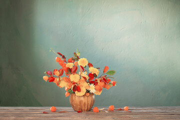 beautiful autumnal  bouquet on wooden table on dark wall