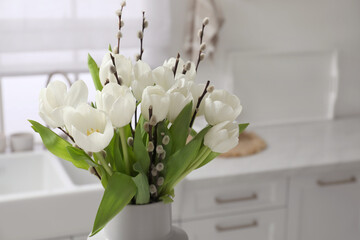 Wall Mural - Beautiful bouquet of willow branches and tulips in vase indoors, space for text