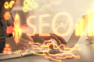 Poster - Double exposure of woman hands working on computer and seo hologram drawing. internet search concept.