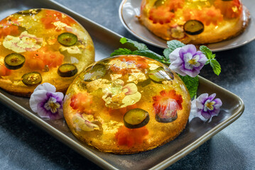 Canvas Print - Lemon jelly globes with fresh fruit, edible flowers and gold flakes on pistachio biscuit - gourmet dessert