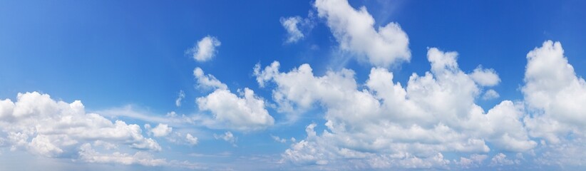 white cumulus clouds on clear blue sky background panorama, beautiful cloudscape wide panoramic view