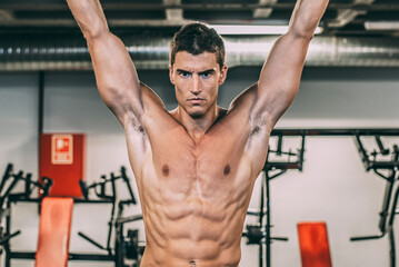 Muscular man doing chin-ups