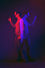 Wall Mural - man is using virtual reality headset. image with double color exposure effect.