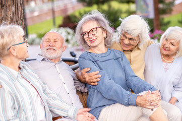 Group of senior friends bonding at the park - Elderly old people meeting and having fun outdoors