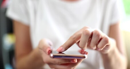 Smartphone user woman touches screen prints and uses online app on mobile phone