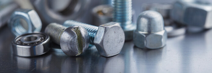 Wall Mural - set of different nuts, bolts, screws, washers and drill bits,thread tap and mill cutters on steel plate background. Locksmithing deal.