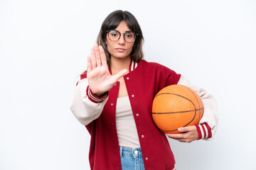 Canvas Print - Young caucasian woman playing basketball isolated on white background making stop gesture