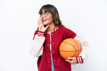 Canvas Print - Young caucasian woman playing basketball isolated on white background shouting with mouth wide open to the side