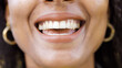 Portrait of young black females mouth as she smiles to camera