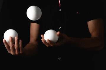 close up portrait of juggling balls, on black background