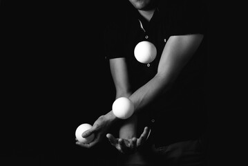 Wall Mural - close up portrait of juggling balls, on black background