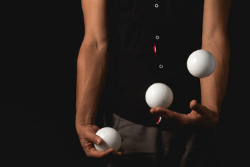 Wall Mural - close up portrait of juggling balls, on black background