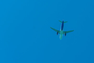 Wall Mural - Aircraft in white blue coloring against the blue sky.