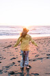 Girl wearing hat at sunset at the beach in Oregon