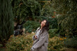 © olga pink - Portrait of pretty asian kazakh brunette woman with charming smile walking along outdoors