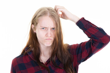 Wall Mural - young puzzled woman scratching head thinking about wrong bad problem on white background girl facial expression emotion