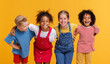 © JenkoAtaman - Group of cheerful happy multinational children on  yellow background