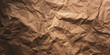 crumpled brown wrapping paper for packaging or handicraft work with abstract folds and texture