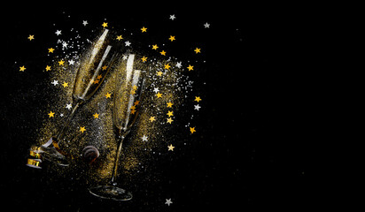 Two glasses of champagne with glitter and splash. Celebration theme.