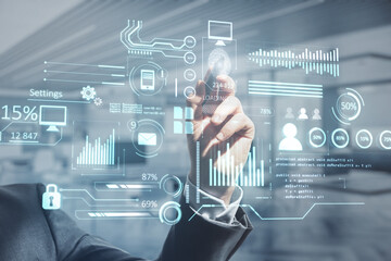 Aufkleber - Close up of business man hand pointing at creative glowing business chart interface hologram on blurry office interior background. 
