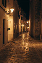 Spain, Balearic Islands, Ciutadella De Menorca, Empty Illuminated Alley At Night