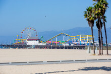 Photo For Pacific Park With Ferris Wheel On The Santa Monica Pier Over Beach Sand On Bright Sunny Daytime