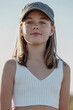 © Westend61 - Smiling cute girl wearing cap on sunny day