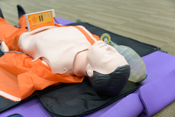 Wall Mural - Demonstrating CPR training medical procedure on CPR doll by Automated External Defibrillator, AED technic in the class. First aid for safe life concept.