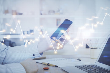 Poster - Double exposure of man's hands holding and using a digital device and forex graph drawing. Financial market concept.