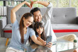 © aekkorn - Happy Asian family making heart symbol in living room while video call.  Family,love and happiness concept.
