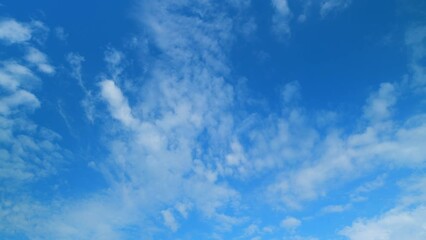 Wall Mural - Summer clouds float across blue sky. Blue sky white clouds. Time lapse.